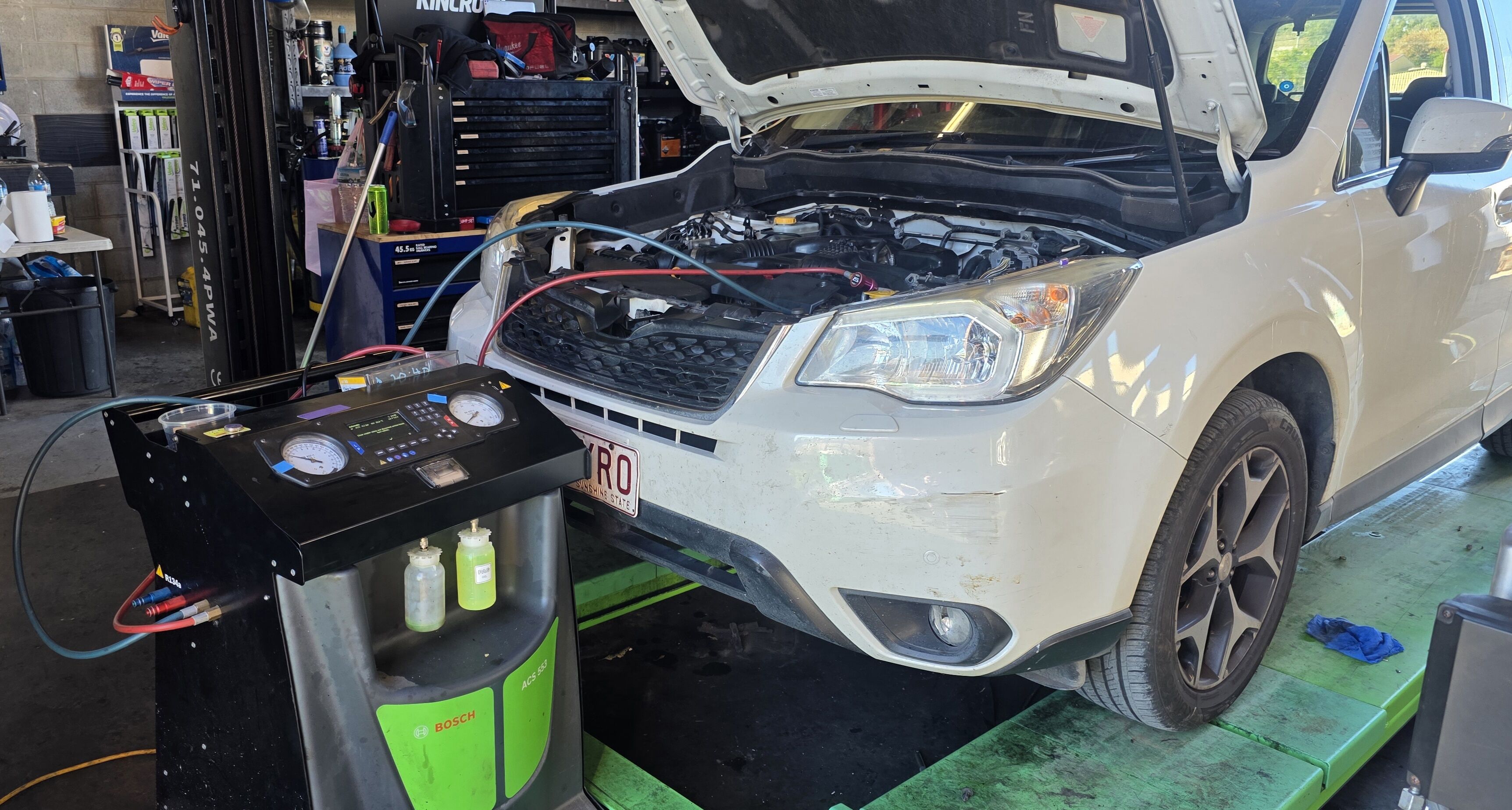 Bosch AC servicing equipment Bosch ACS 553 connected to a vehicle for air conditioning service at our Calliope workshop