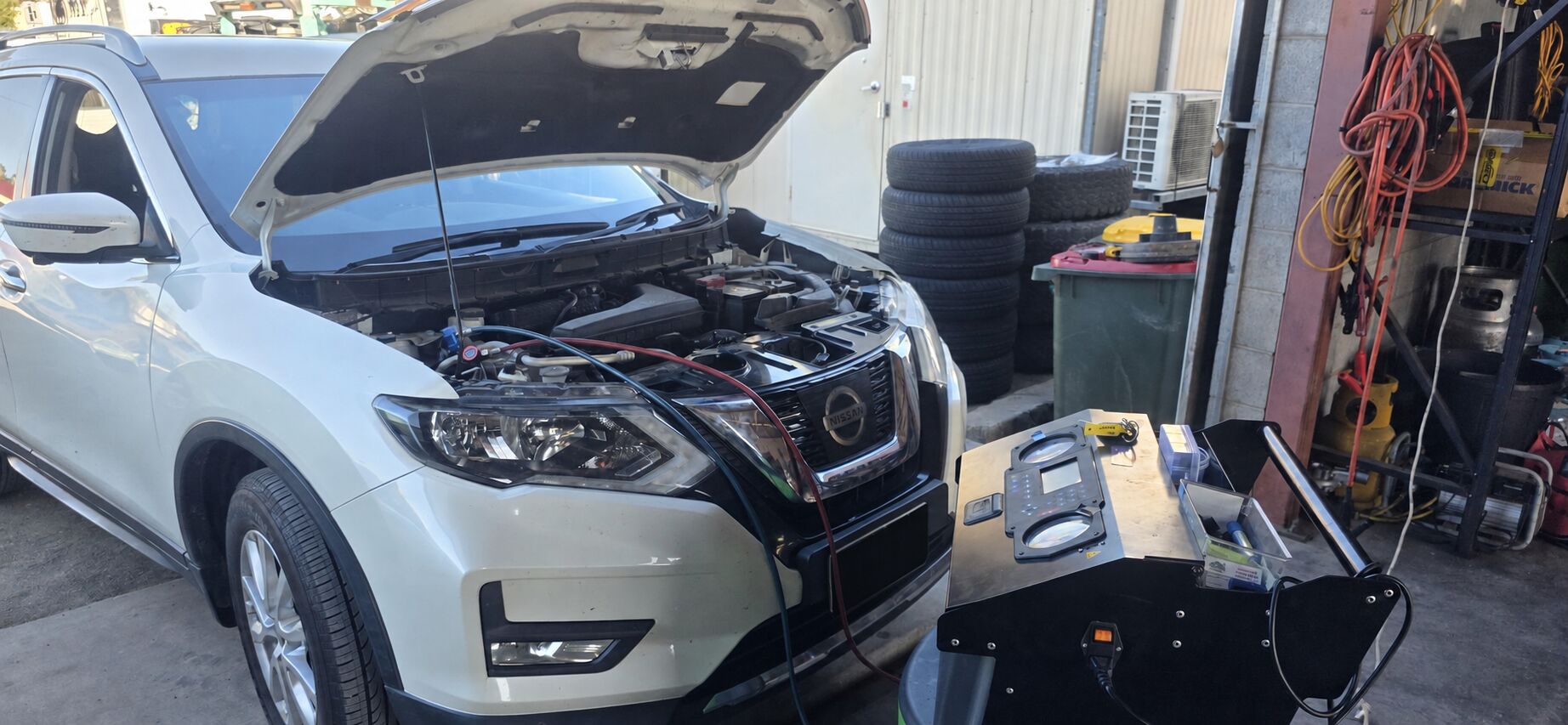 Vehicle AC service in Calliope Vehicle connected to air conditioning service equipment at Total Mobile Mechanical Services